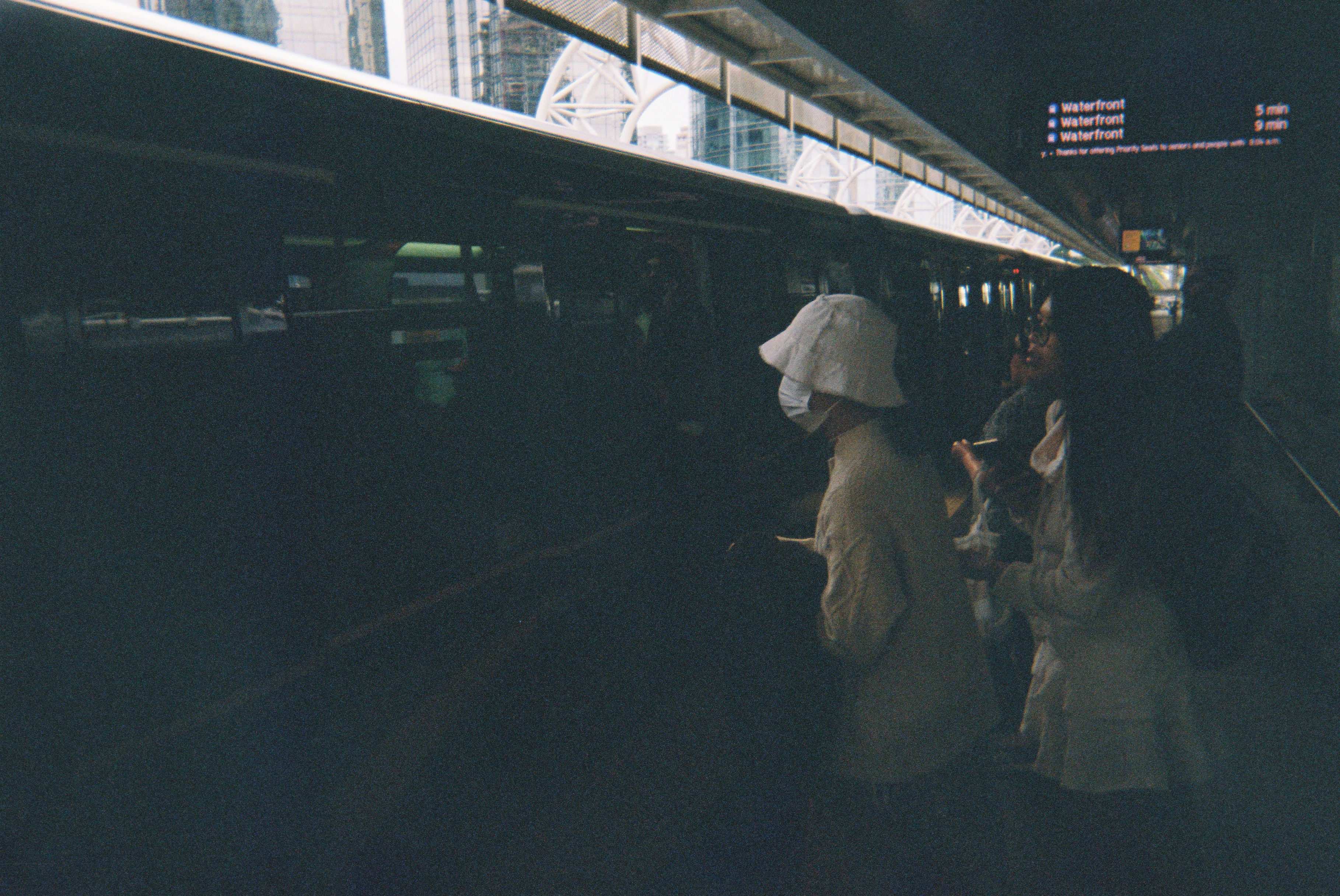 A slightly underexposed image of people getting on the Vancouver SkyTrain